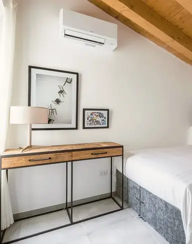 a bedroom with a bed and a desk