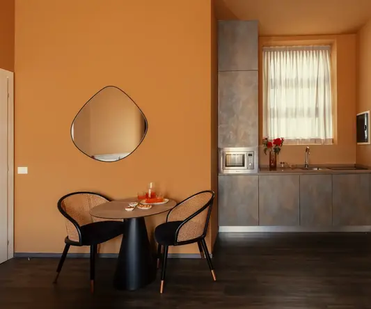 a kitchen with a table and chairs