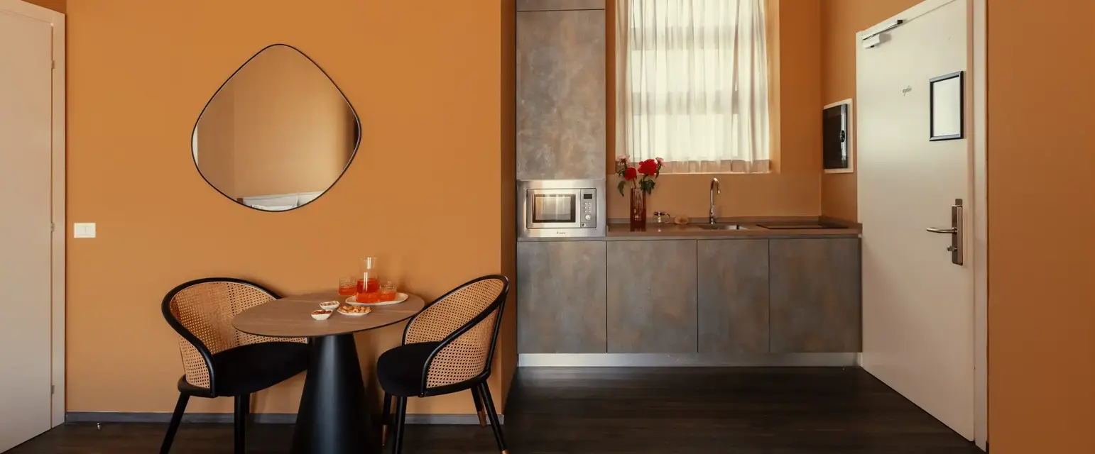 a kitchen with a table and chairs