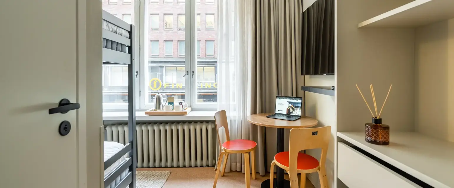 a small room with a desk and a bunk bed