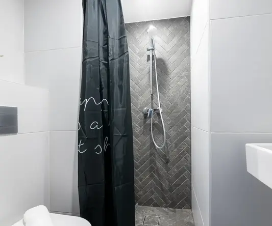 a shower with a black curtain