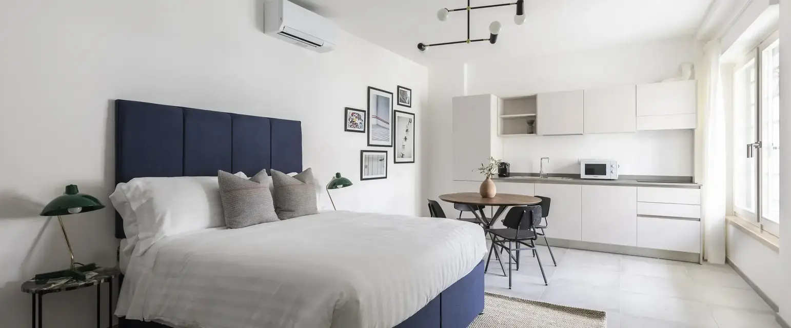 a bedroom with a bed and a table