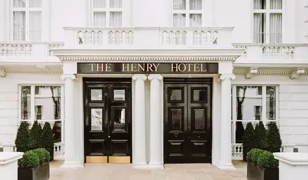 a building with black doors and white columns