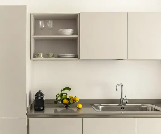 a kitchen with white cabinets and a sink
