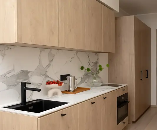 a kitchen with wood cabinets and a sink