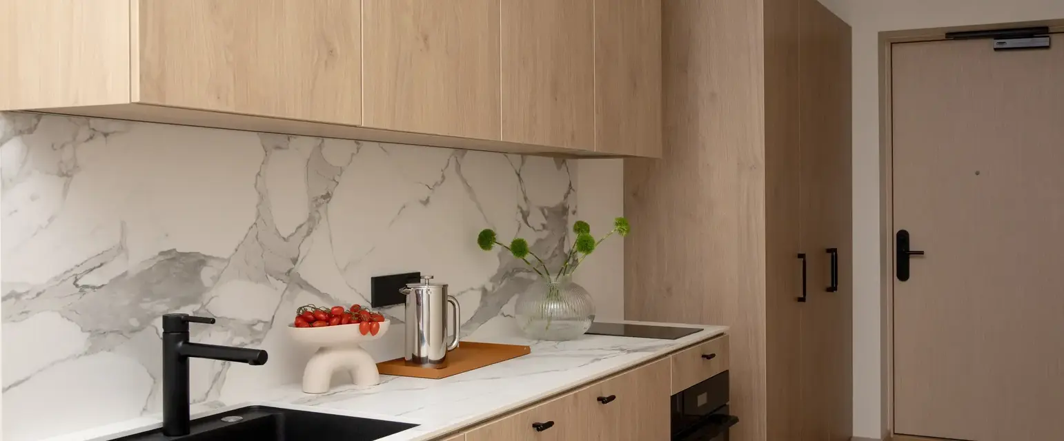 a kitchen with wood cabinets and a sink