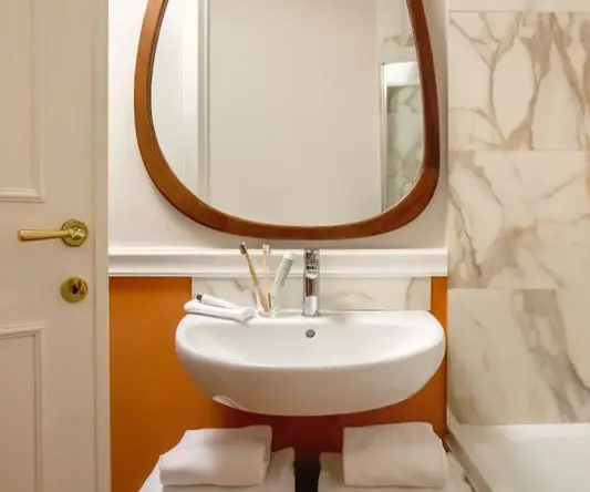 a bathroom with a mirror and sink