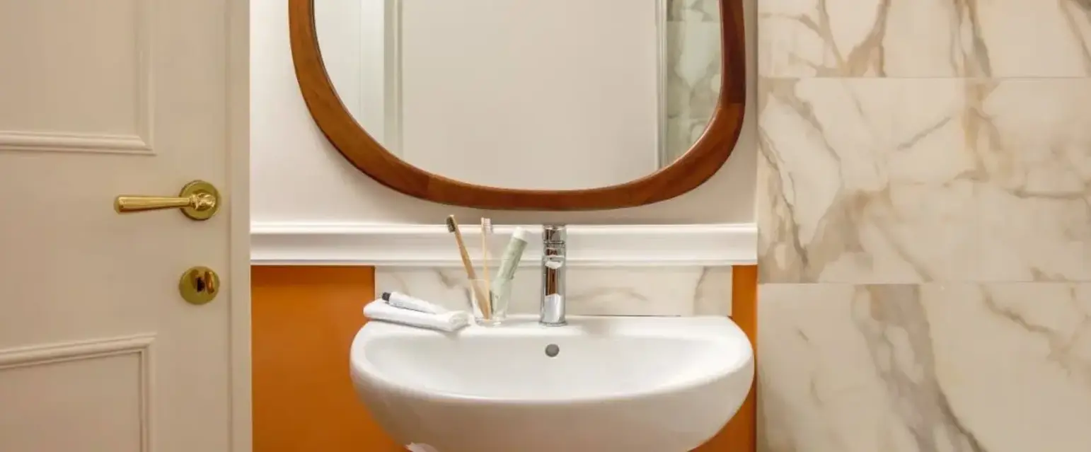 a bathroom with a mirror and sink