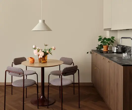 a kitchen with a table and chairs