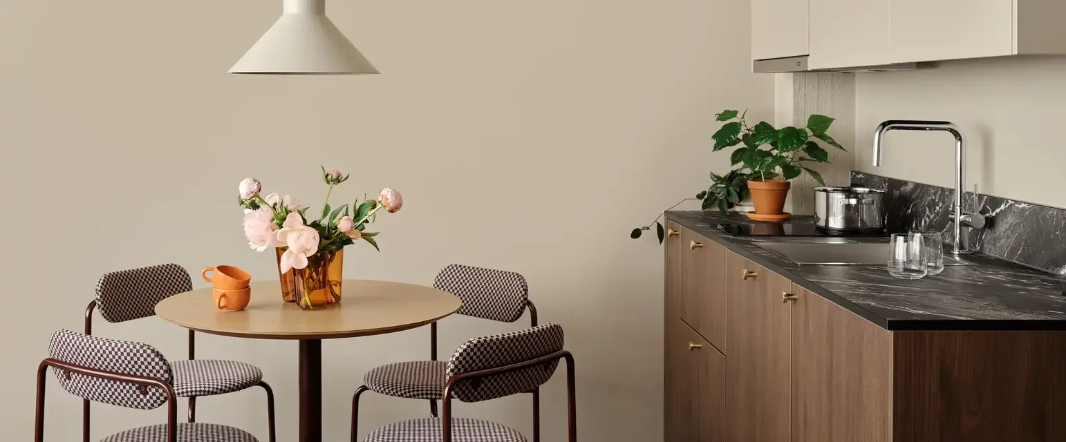 a kitchen with a table and chairs