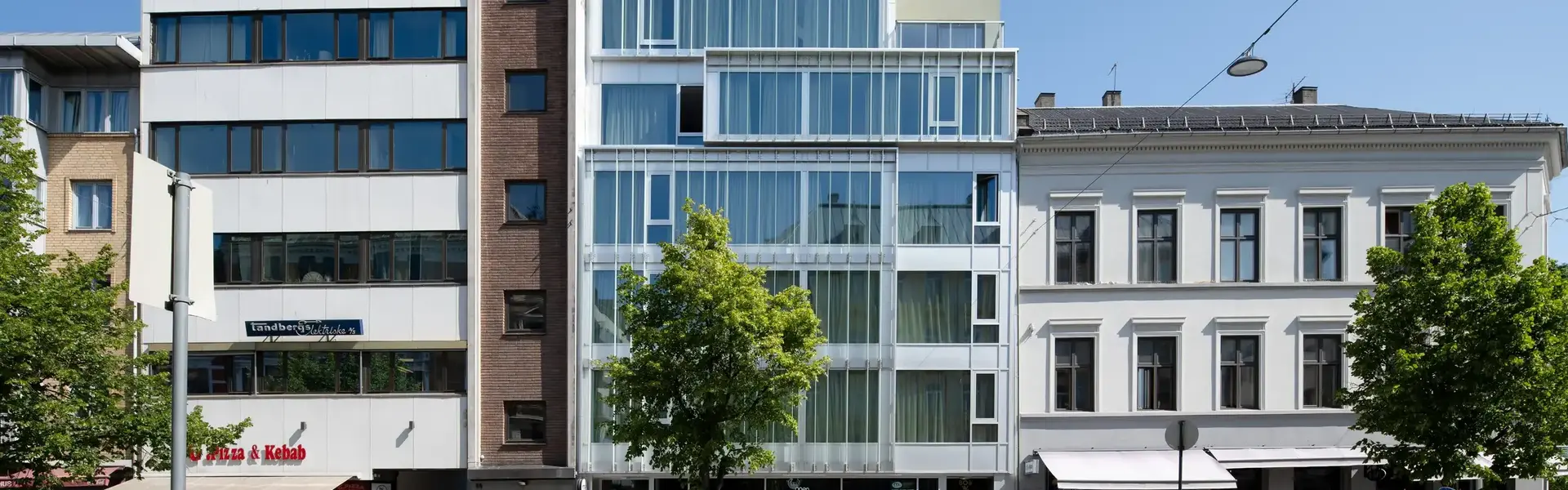 a street with a tree and buildings