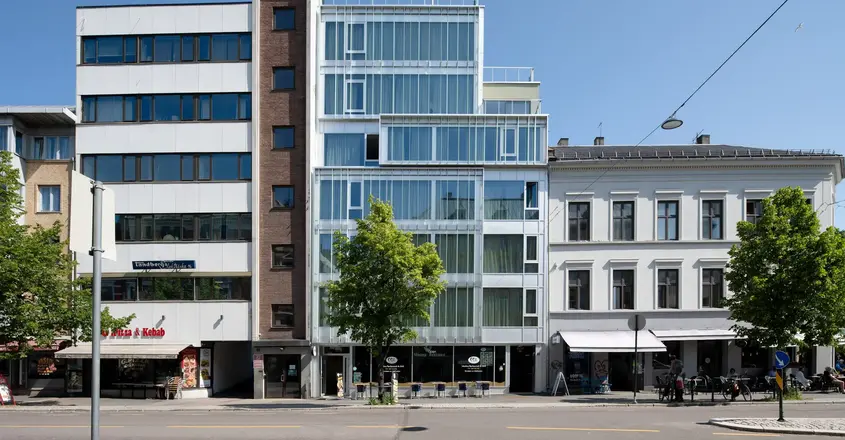 a street with a tree and buildings