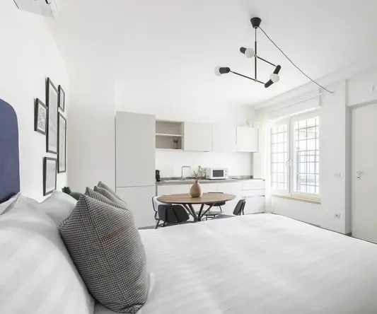 a bedroom with a table and chairs