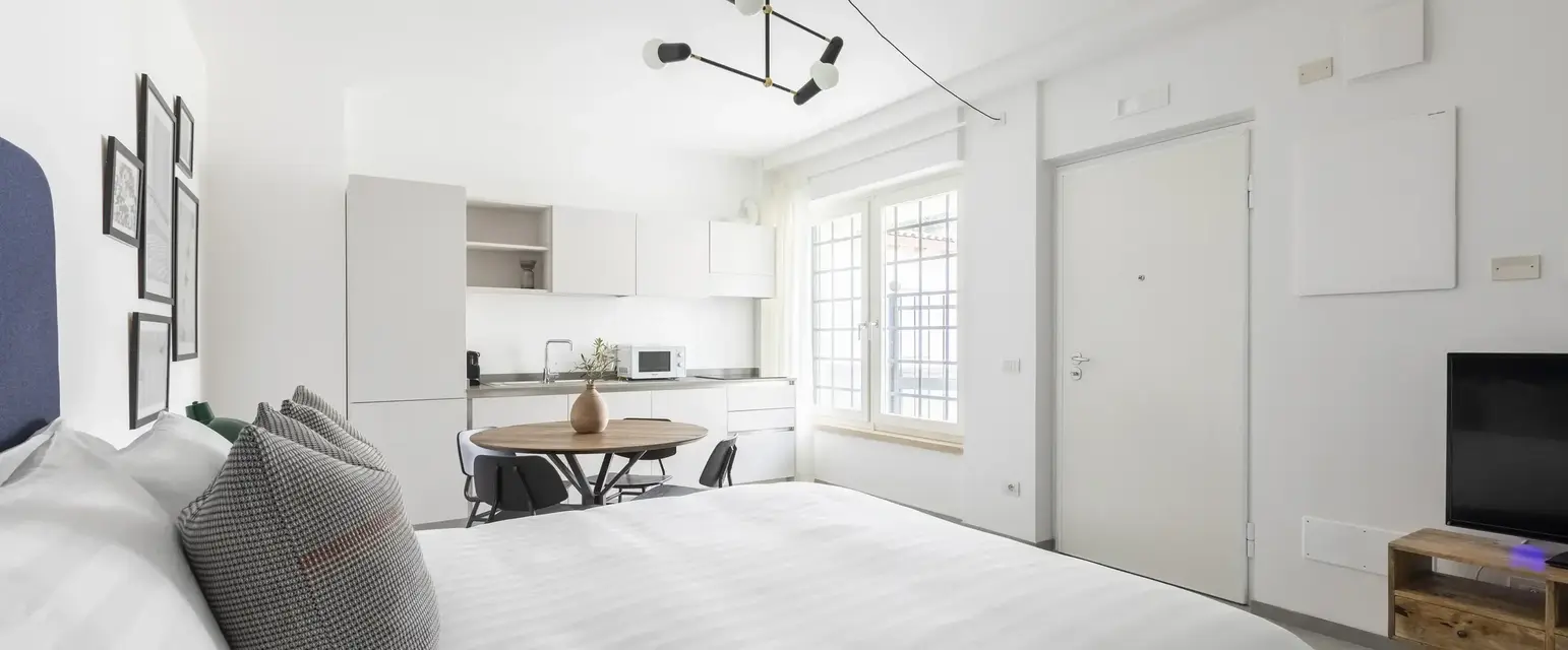 a bedroom with a table and chairs