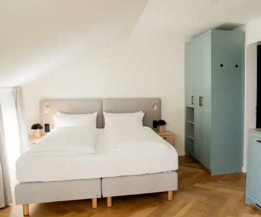 a bedroom with a bed and cabinets