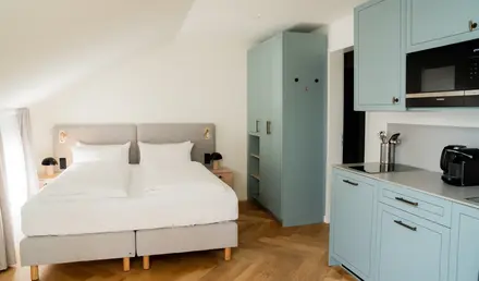 a bedroom with a bed and cabinets