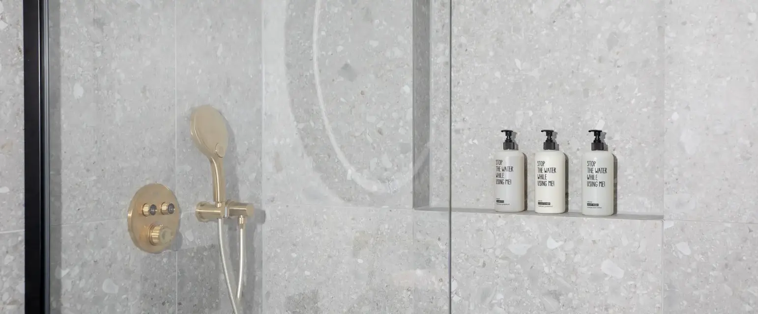 a shower with a shower head and shower head