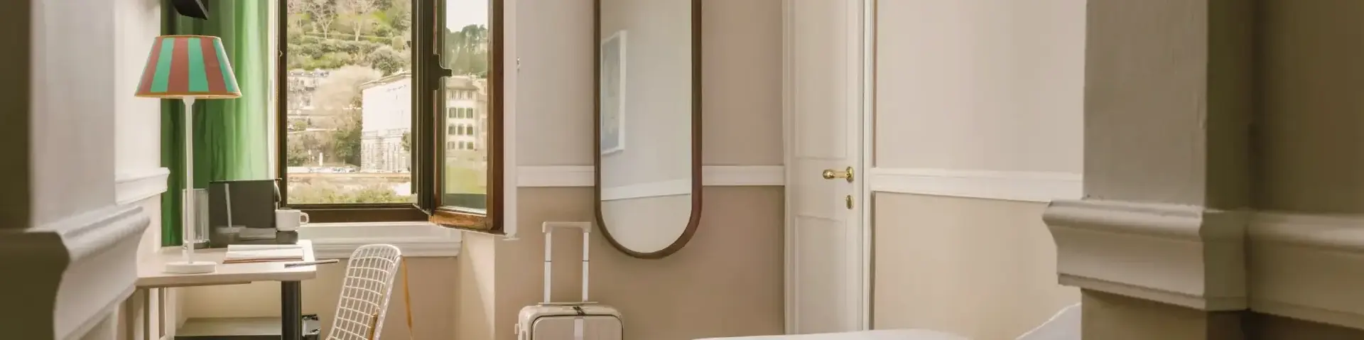 a room with a bed and a desk and a mirror