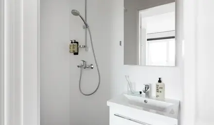 a bathroom with a shower and sink
