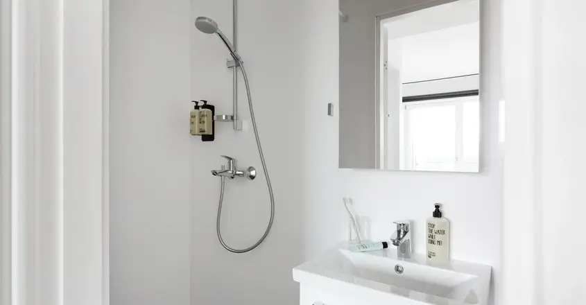 a bathroom with a shower and sink