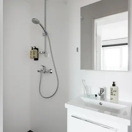 a bathroom with a shower and sink