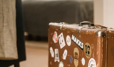 a suitcase with stickers on it