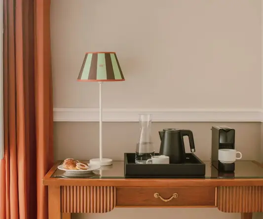 a tray with coffee and a lamp on a table