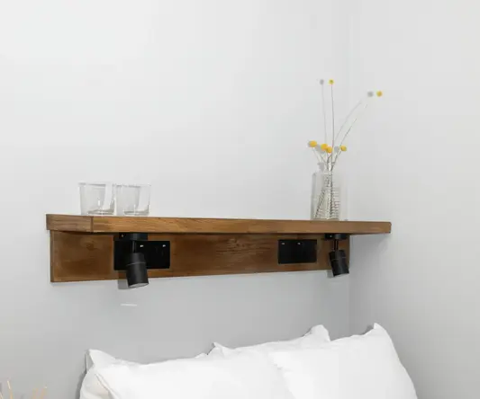 a bed with white sheets and pillows