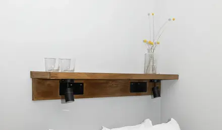 a bed with white sheets and pillows