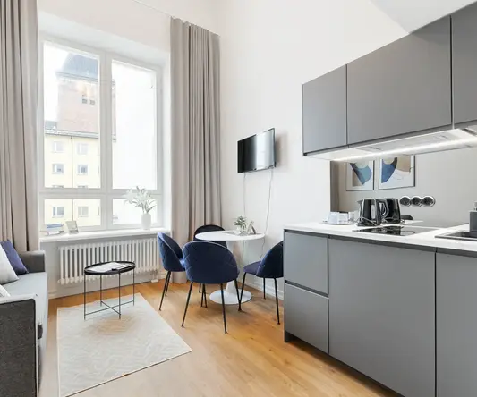 a kitchen and dining area with a tv and a table