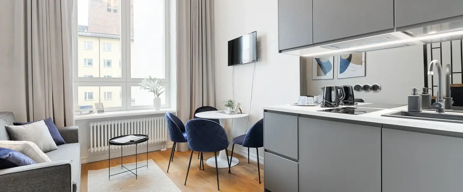 a kitchen and dining area with a tv and a table