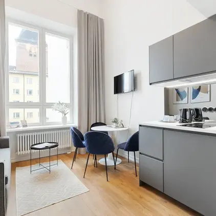 a kitchen and dining area with a tv and a table