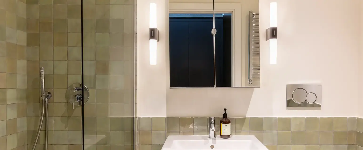 a bathroom with a mirror and a sink