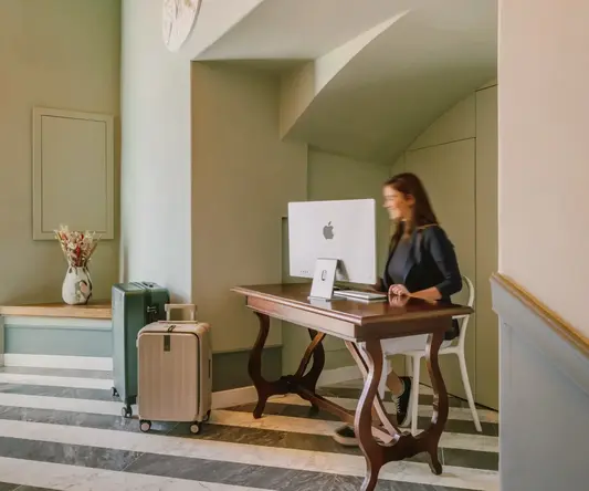 a woman sitting at a desk with a computer