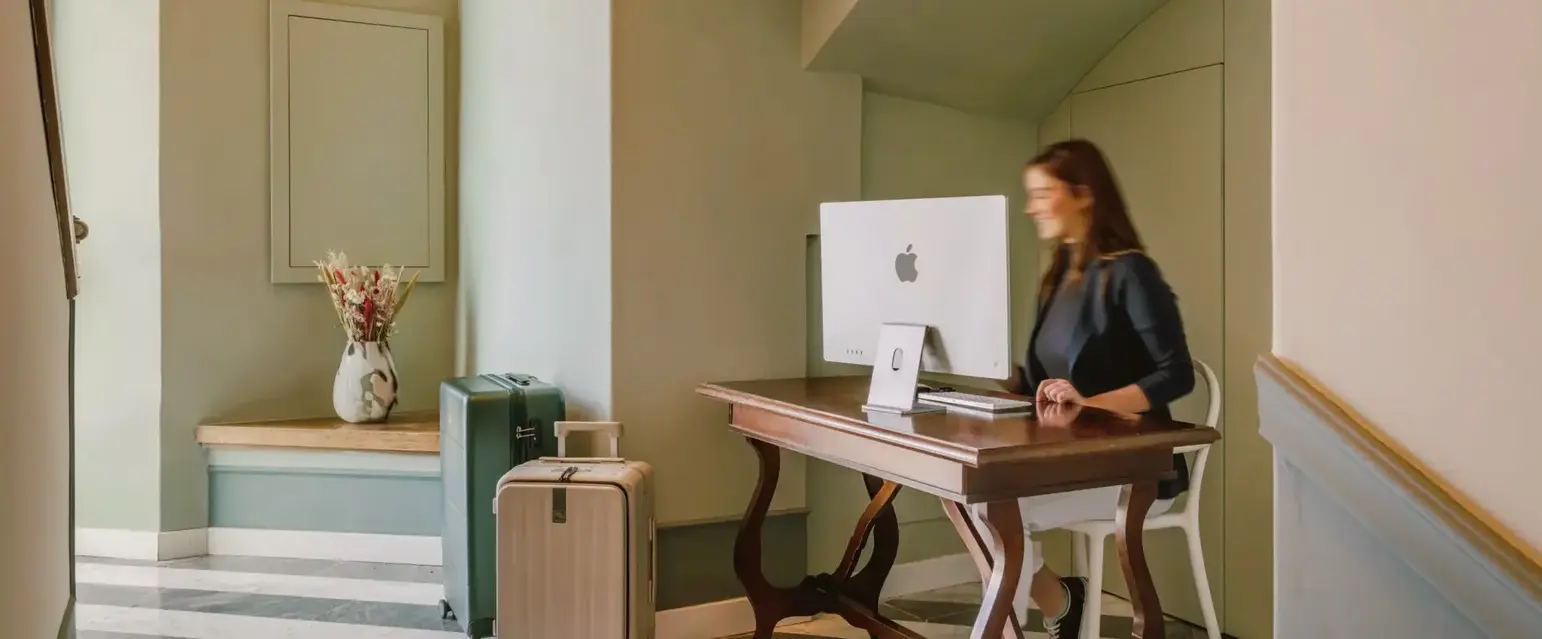 a woman sitting at a desk with a computer
