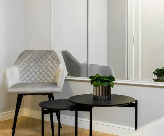 a room with a white chair and a black table