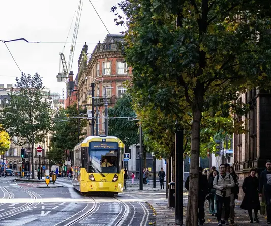 a yellow train on a street - Photo by Mangopear creative on Unsplash