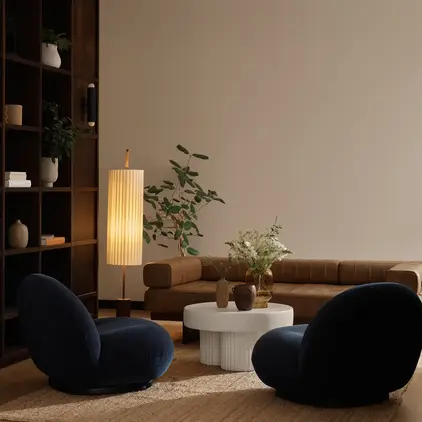 a living room with a couch and a lamp