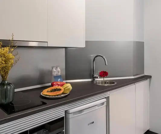 a kitchen with white cabinets and a sink