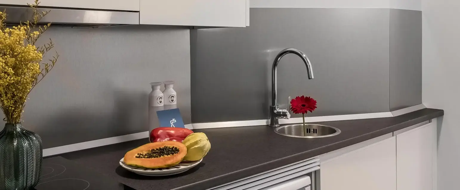 a kitchen with white cabinets and a sink