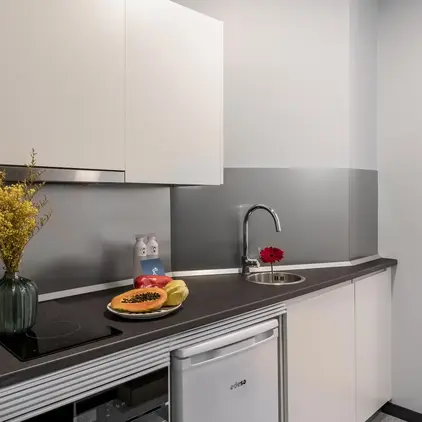 a kitchen with white cabinets and a sink