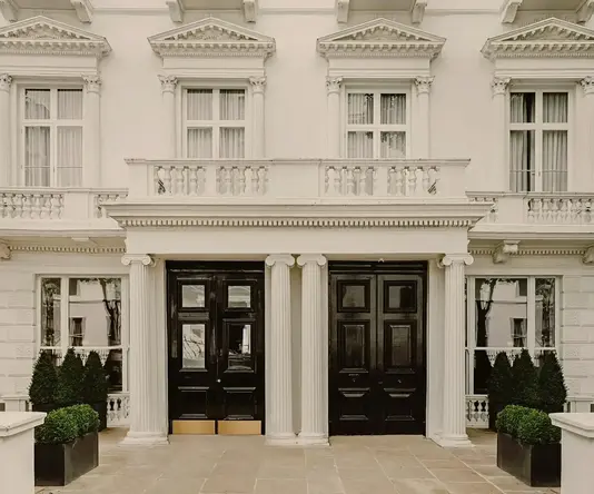 a building with columns and black doors