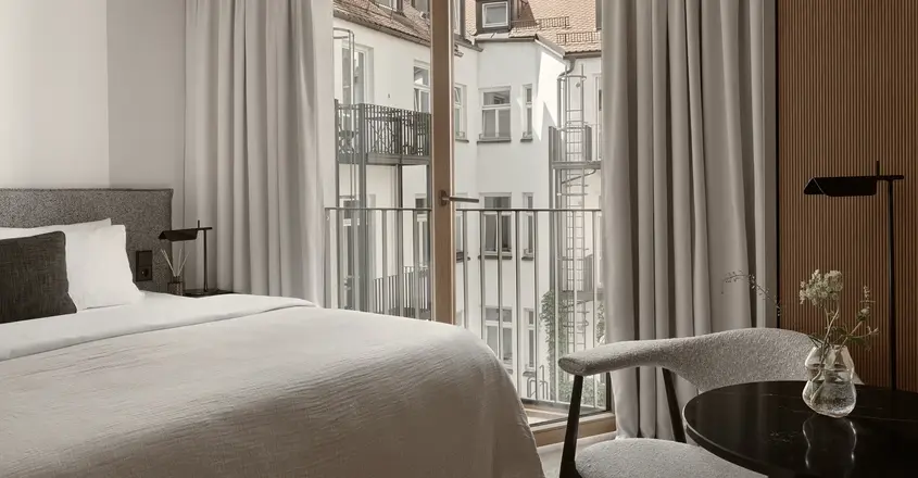 a bedroom with a bed and a chair