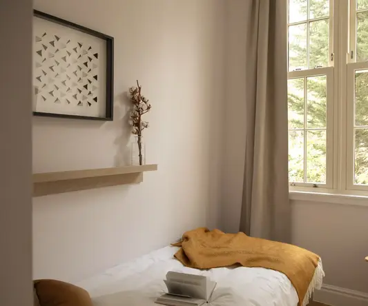 a bed with a blanket and a book on it