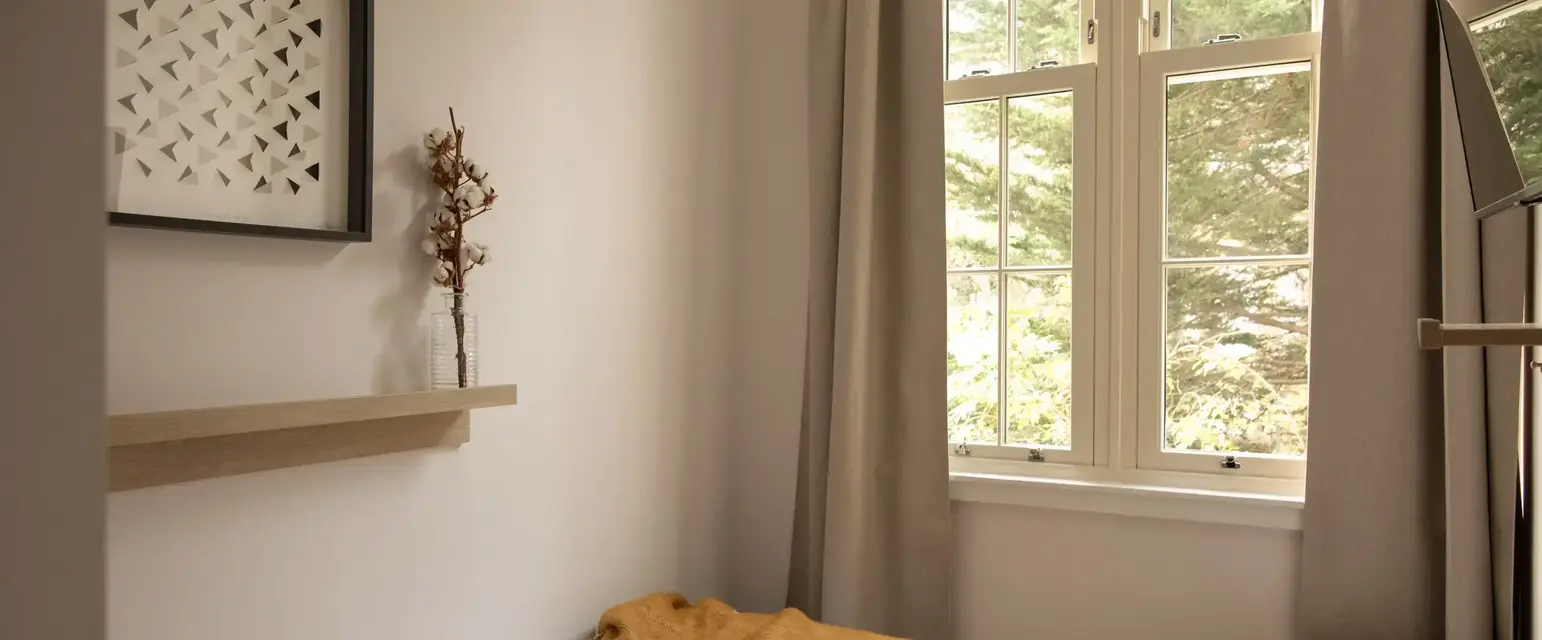 a bed with a blanket and a book on it