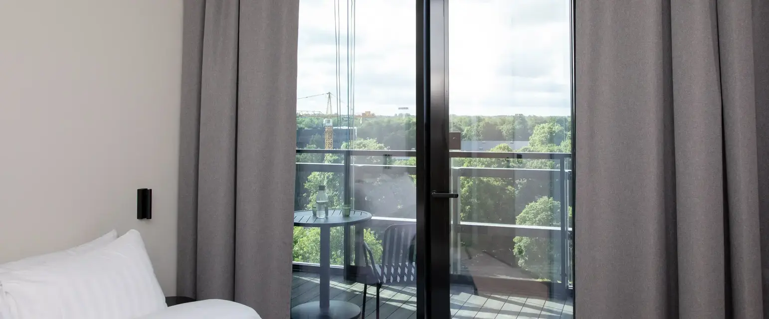 a bedroom with a glass door and a balcony