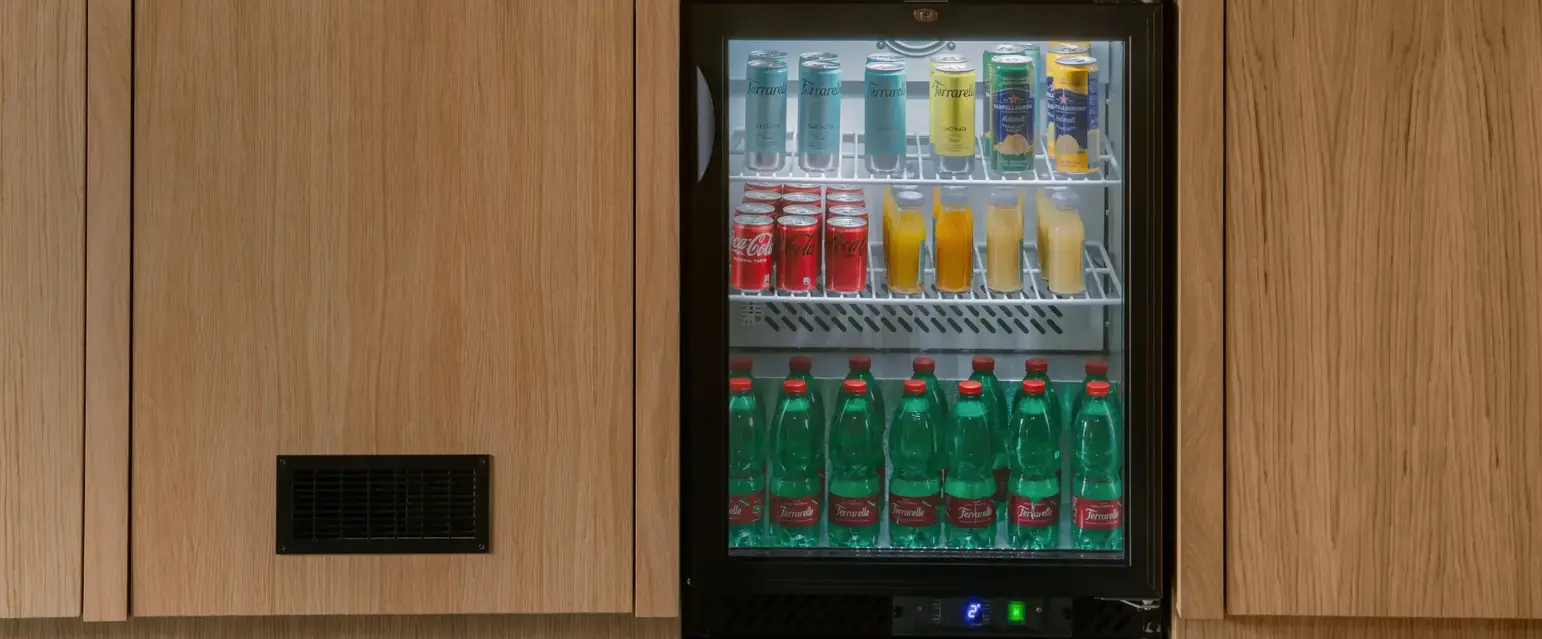 a mini fridge with drinks in it