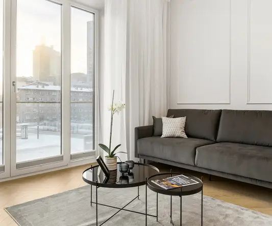 a living room with a couch and coffee tables