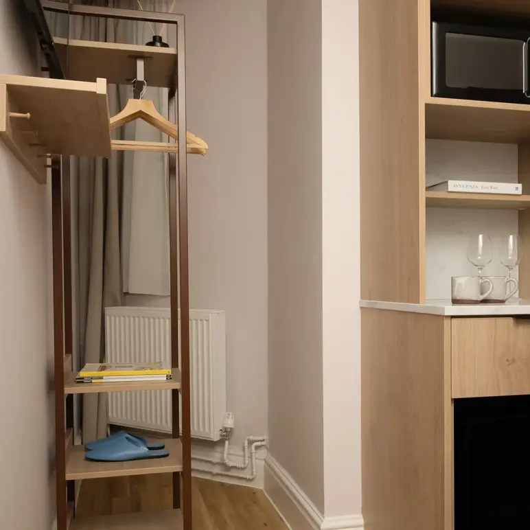 a room with a shelf and a microwave