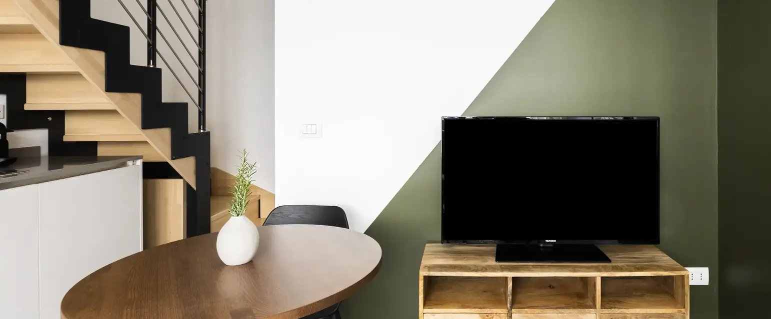a table and chair in a room with a tv